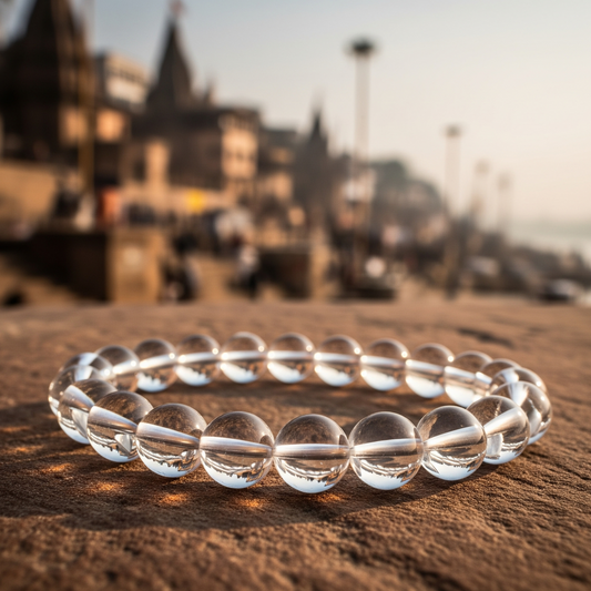 Clear beaded bracelet on a textured surface with a blurred background